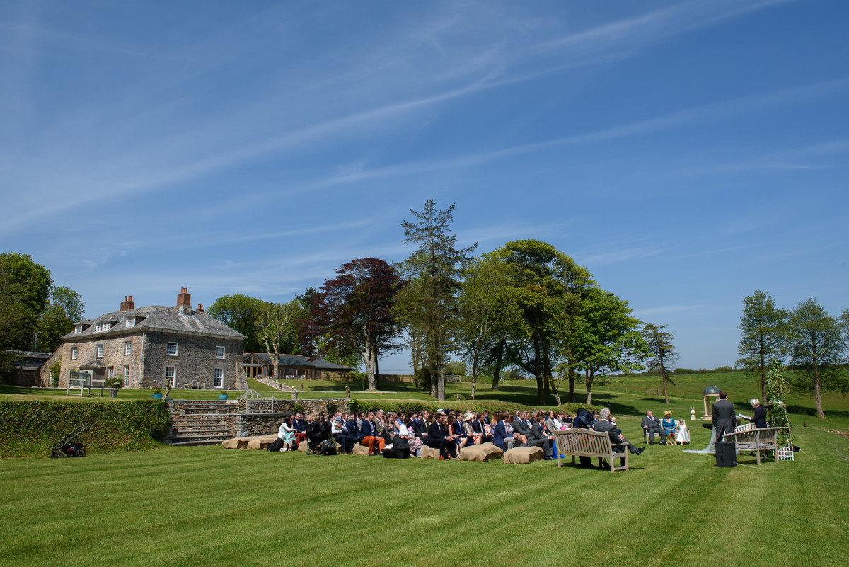 outdoor ceremony on the lawn in the sunshine at Tredudwell Manor