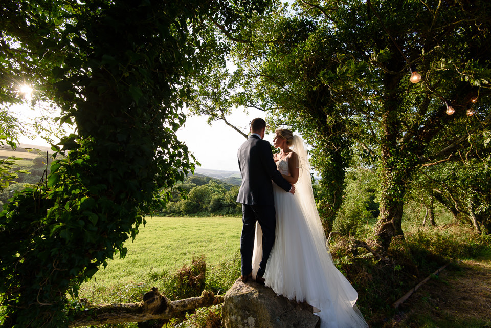 Bride and groom enjoying the late evening sunshine in Devon